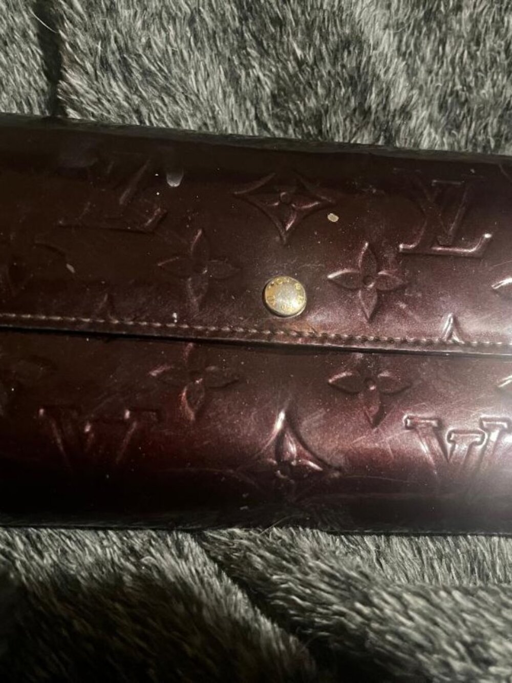 This is a  Louis Vuitton Monogram Vernis Portefeuille Sarah wallet.